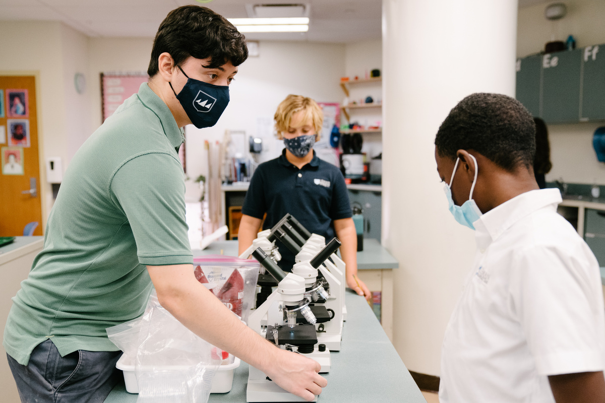 Teacher and student with a microscope 